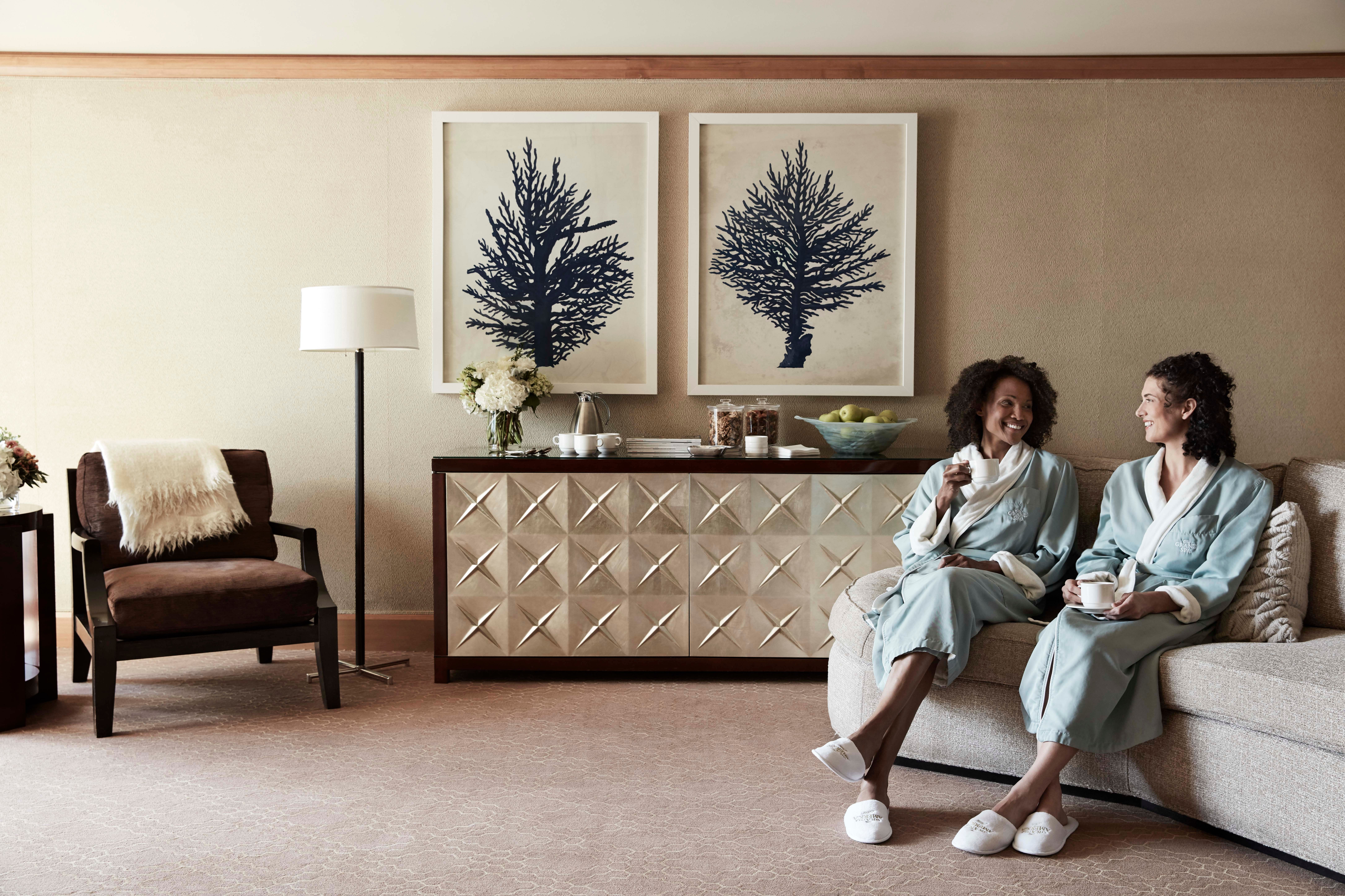 Couple sitting on a couch in robes