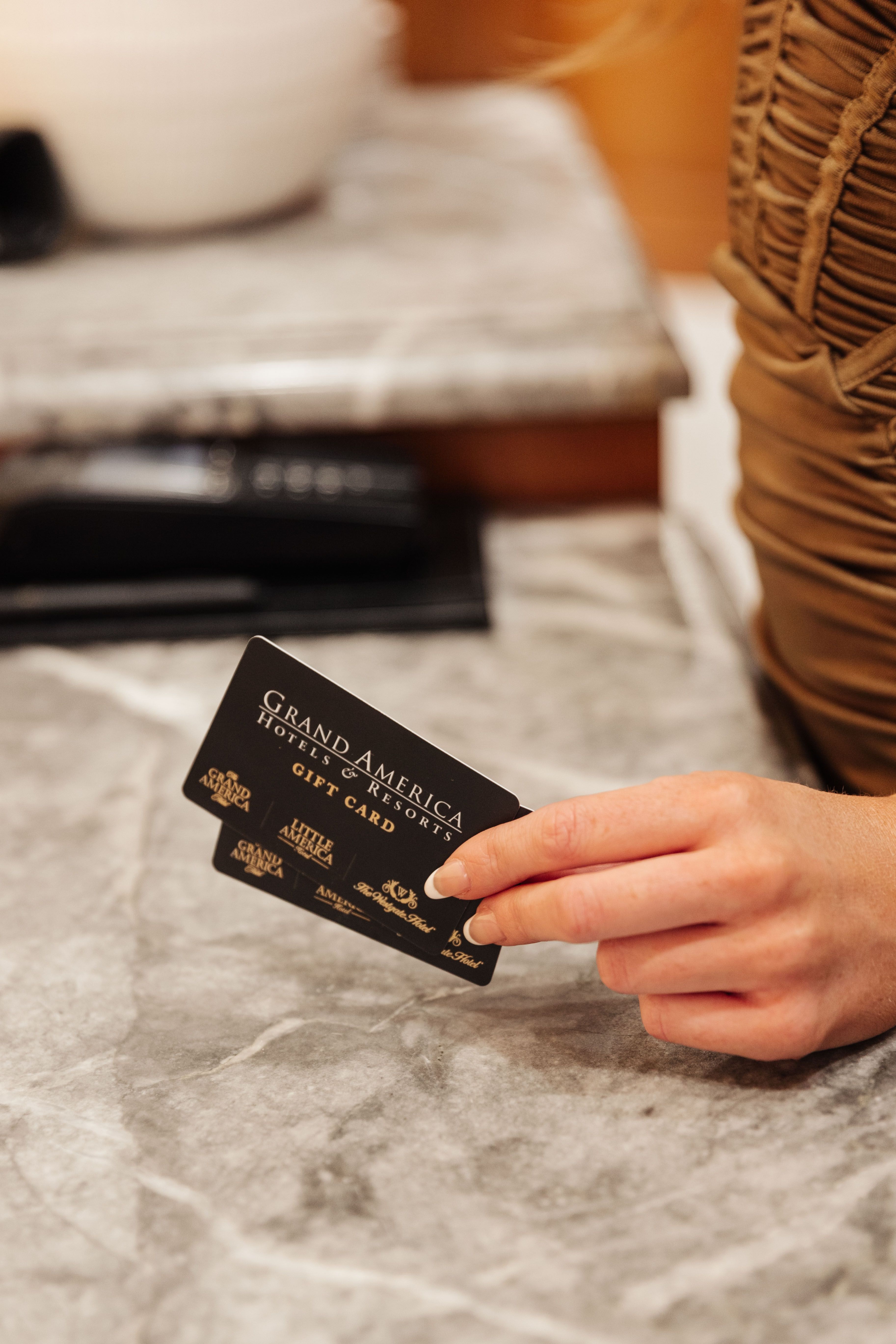 Hand holding two gift cards