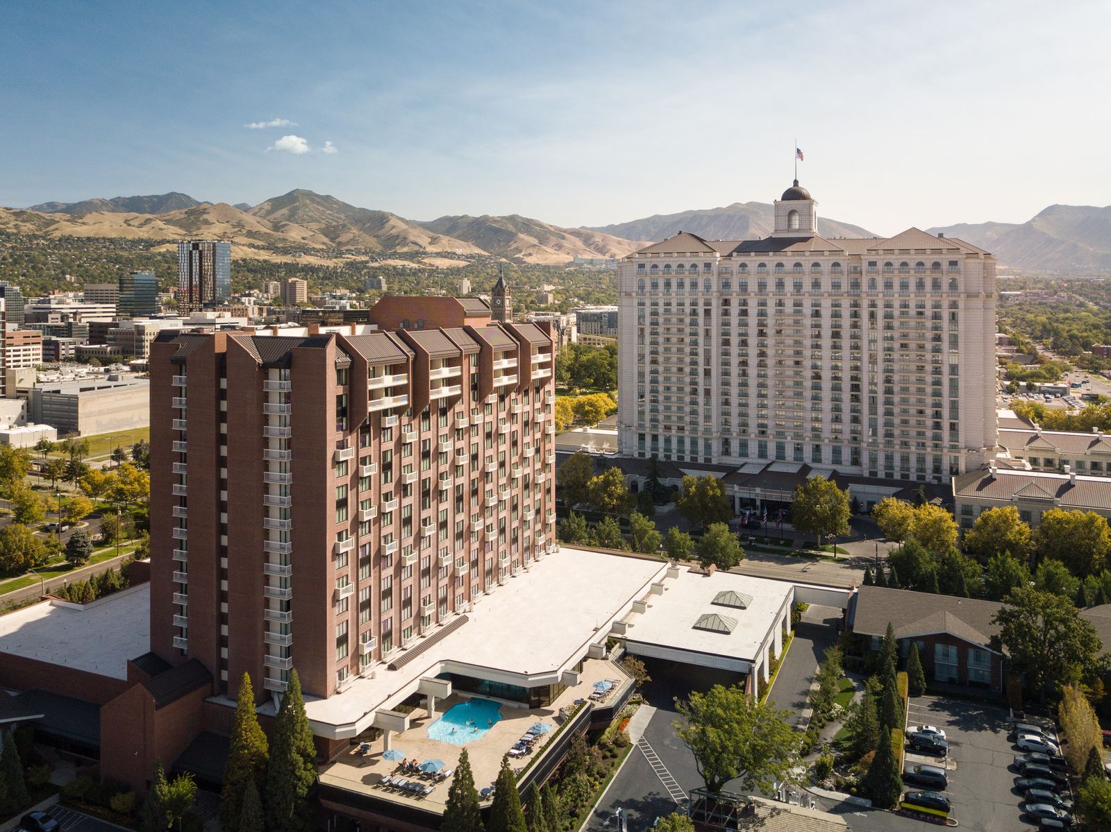 Grand and Little America Hotels against the Salt Lake City skyline and Wasatch Mountains