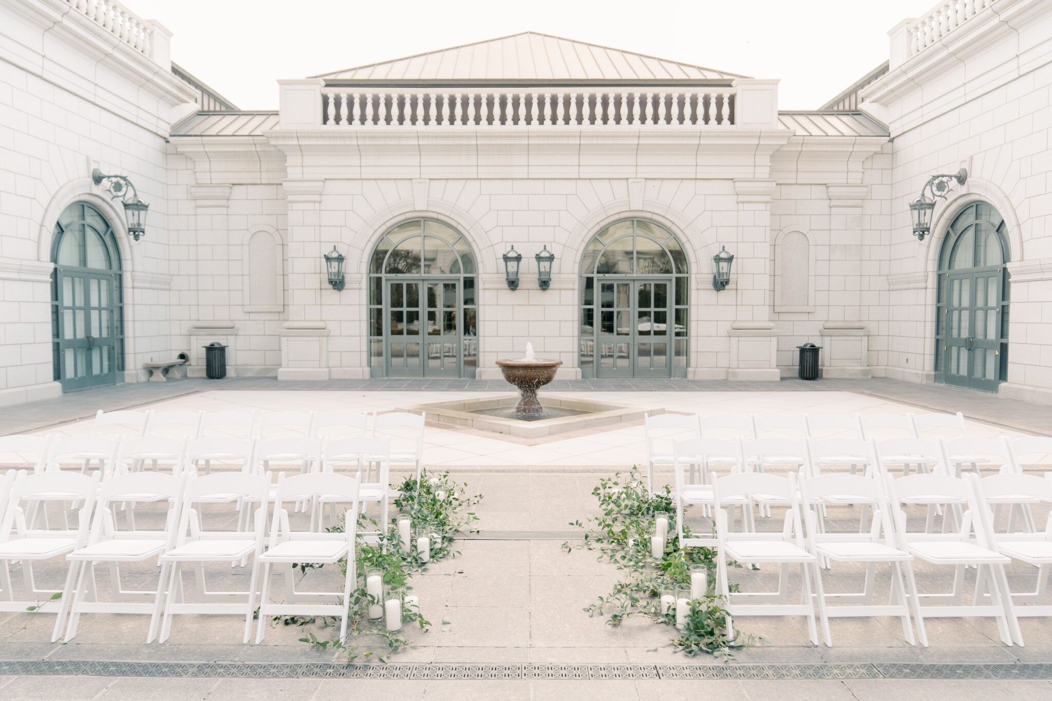 Grand America Courtyard set up for a wedding with rows of white chairs.