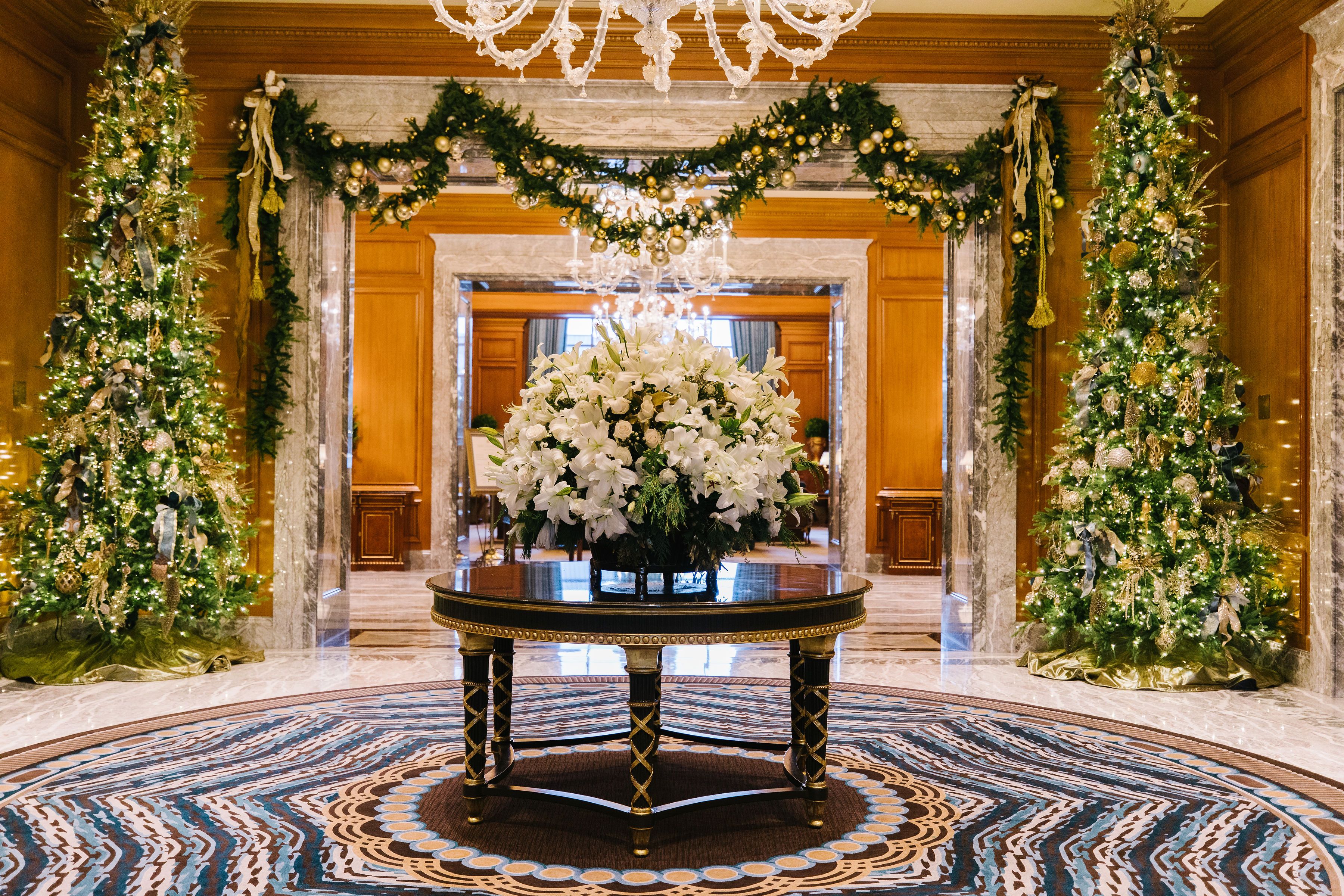 Lobby decorated with Christmas trees and garlands