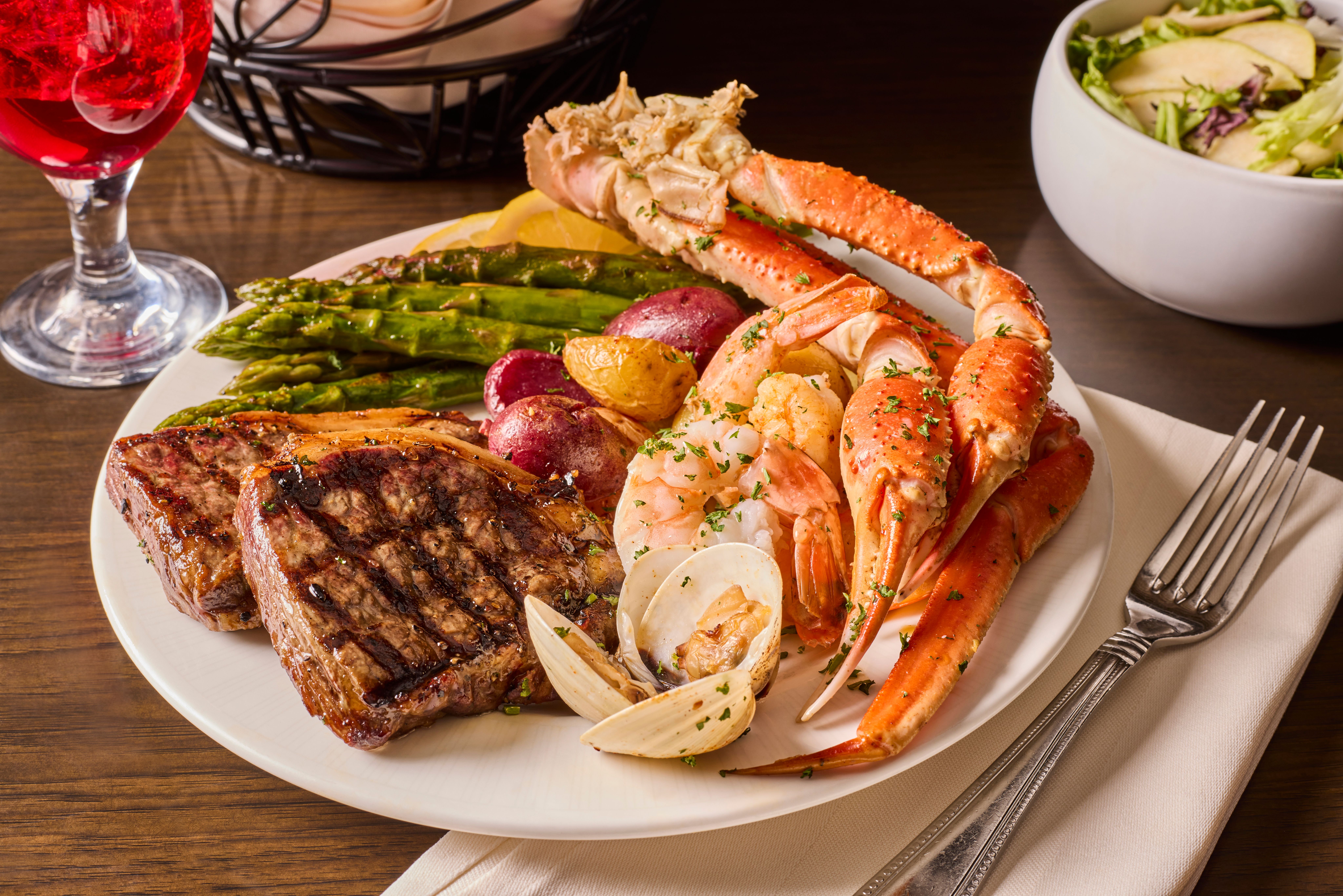 Pate with steak, crab legs, potatoes, and asparagus